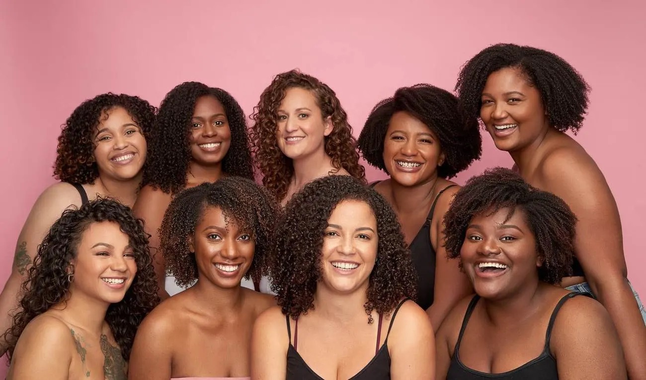 9 women with curly hair smiling in a CurlMix photoshoot